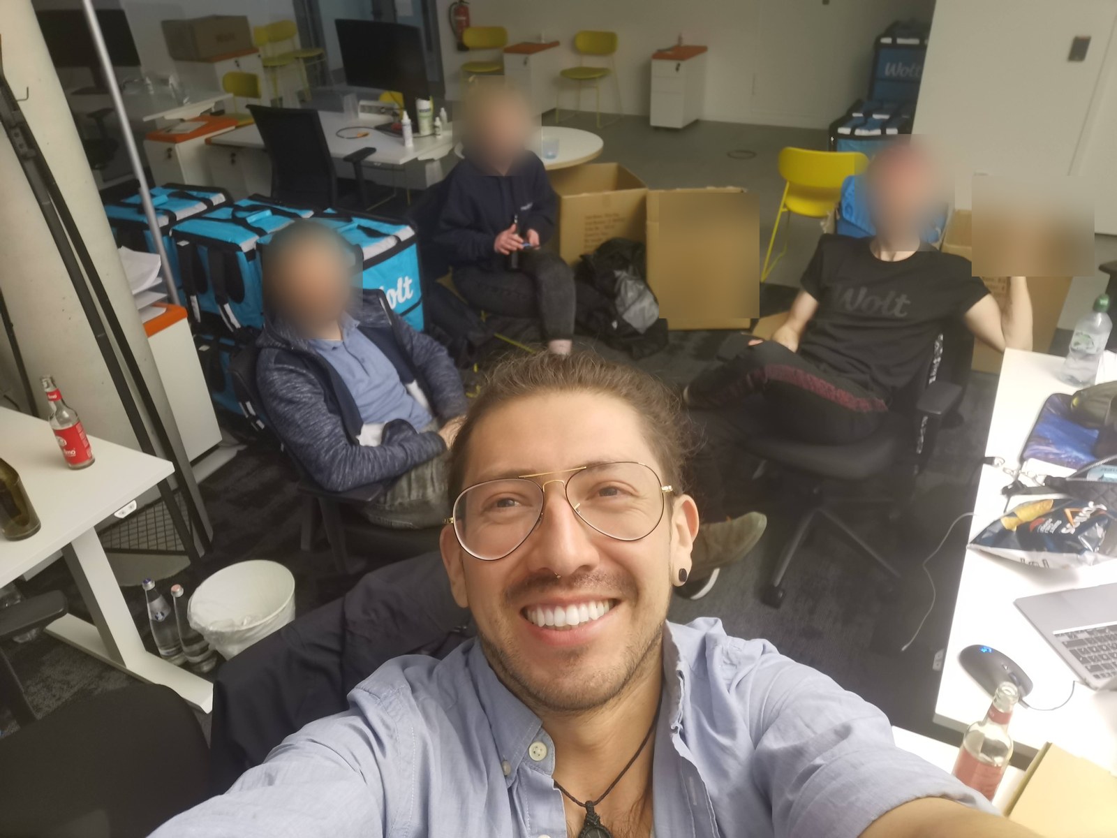Jorge Aguilar with the gear team at the Wolt Berlin office, surrounded by thermal boxes and packing cartons at the end of a shift.